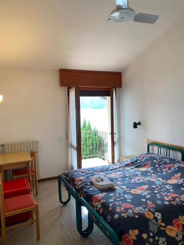 Schlafzimmer mit einem Bett und einem Fenster in der Unterkunft Albergo Campeggio Bommartini in Malcesine