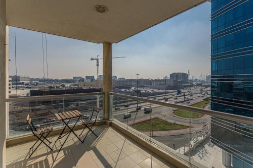 a balcony with a view of a city with traffic at HiGuests - Cheerful Apt With Stunning Views in Port Saeed in Dubai