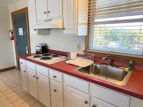 a kitchen with a sink and a counter top at Pony Island Inn in Ocracoke