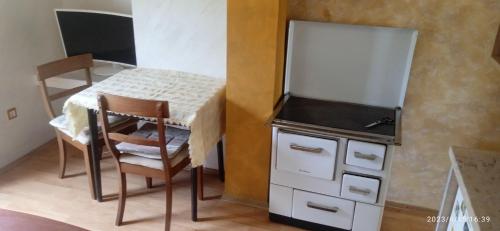 a small kitchen with a table and a chair next to a counter at Vlado 