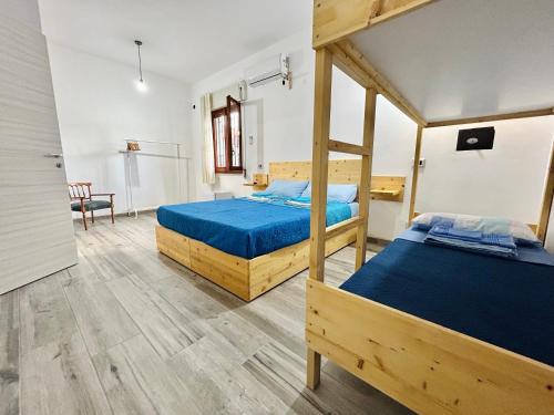 a bedroom with two bunk beds and a table at Thalassa Casa Vacanza in Anzio
