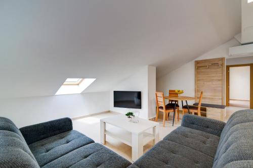 a living room with two couches and a table at Villa Panorama in Senj