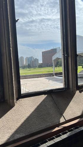 an open window with a view of a field at Administración Almafuerte in Mar del Plata