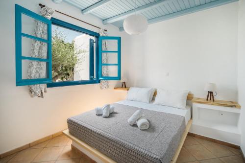 a bedroom with a bed and a window at Niel Serifos in Serifos Chora