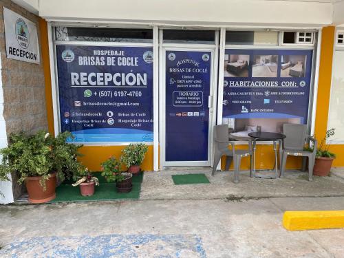 a front door of a restaurant with a table and chairs at Brisas de Coclé in Penonomé