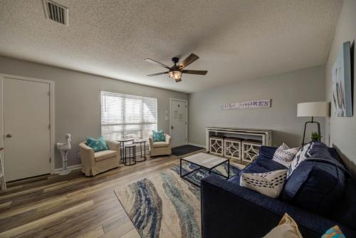 a living room with a couch and a ceiling fan at Sea Horse 112 by Vacation Homes Collection in Gulf Shores