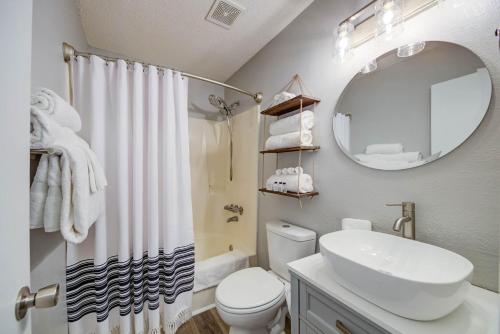 a bathroom with a sink and a toilet and a mirror at Sea Horse 112 by Vacation Homes Collection in Gulf Shores