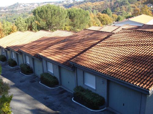an overhead view of a row of houses with tile roofs at Motel Cancun Barbadas-Ourense in Os Fornos