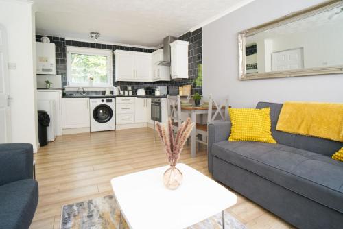 a living room with a couch and a table at Rotherwood Apartment in Glasgow
