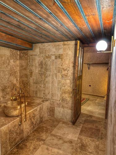 a bathroom with a tub and a sink at Takaev Cave House in Uchisar
