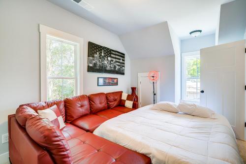 a bedroom with a leather couch and a bed at Quaint Newnan Vacation Rental Near State Park! in Newnan
