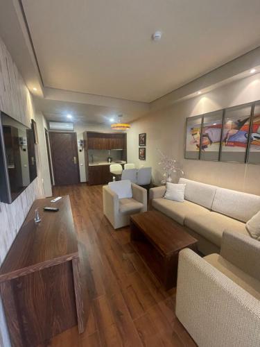 a living room with a couch and a table at Oasis Chakvi apartment 1406 in Chakvi