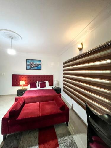 a bedroom with a red bed and a red headboard at Montreal Suite by Jaynice Homes in Lekki