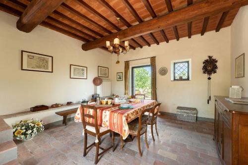 una cucina e una sala da pranzo con tavolo e sedie di La casa di Madina a Montespertoli