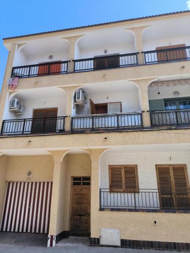 a building with balconies on the side of it at Apartamento en San Pedro del Pinatar in San Pedro del Pinatar