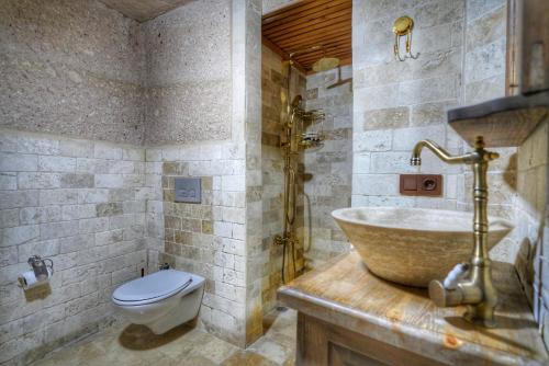 a bathroom with a sink and a toilet at Takaev Cave House in Uchisar