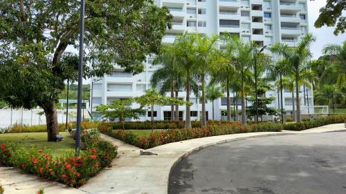 a street in front of a building with flowers at Stunning, Brand-new Apartment in Santa Fe de Antioquia