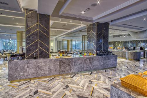 a lobby of a hotel with a marble counter at Al Ahsa InterContinental by IHG in Al Ahsa