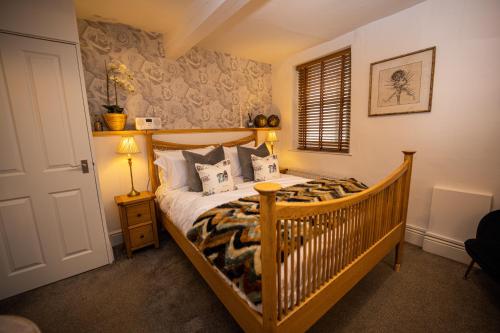 a bedroom with a bed with a crib in it at The Griffin Inn Bath in Bath