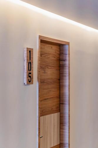 a door in a room with a clock on the wall at Hotel Central Merida by Kavia in Mérida