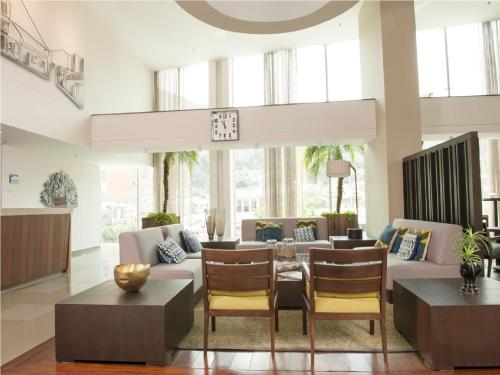 a living room with a couch and a table and chairs at Hotel bh Usaquén in Bogotá
