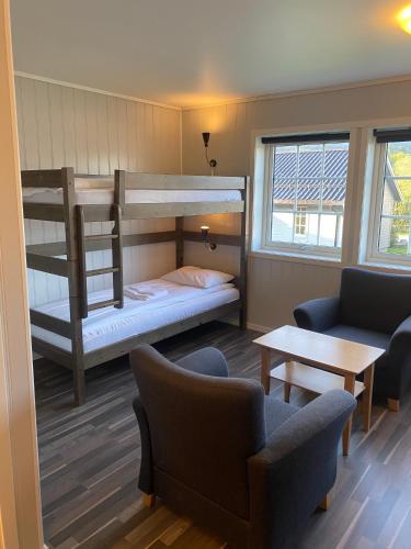 a living room with two bunk beds and a couch at Fjordly Ungdomssenter in Bryggja