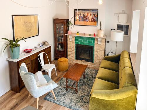 a living room with a couch and a fireplace at Casa Rurale Faraone in Teggiano