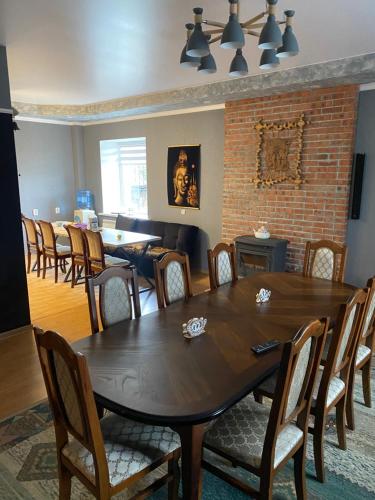 a dining room with a wooden table and chairs at Opushka in Vorobʼyëvka