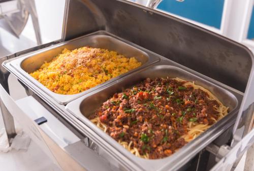 two trays of food sitting in a stove at Minh Chau Pearl Hotel & Spa - Quan Lan Island in Quang Ninh