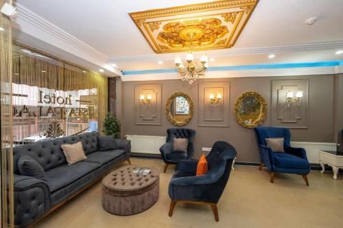 a living room with a couch and chairs and a chandelier at Ista Palace Hotel in Istanbul