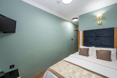 a bedroom with a bed and a flat screen tv at Ista Palace Hotel in Istanbul