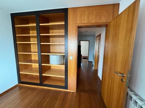 a room with a closet with wooden shelves at Vela Marina, Costa Nova in Gafanha da Encarnação