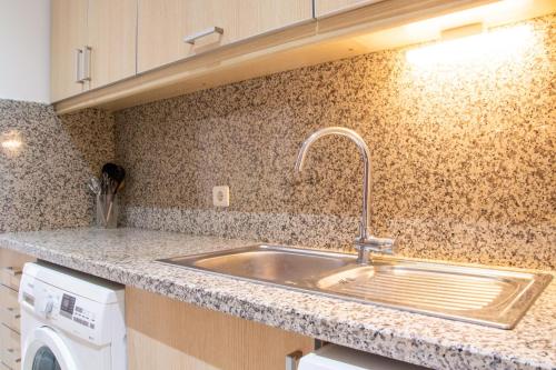 a kitchen counter with a sink and a dishwasher at Comfortable Flat w Pool and Garden in Soke Aydin in Soke