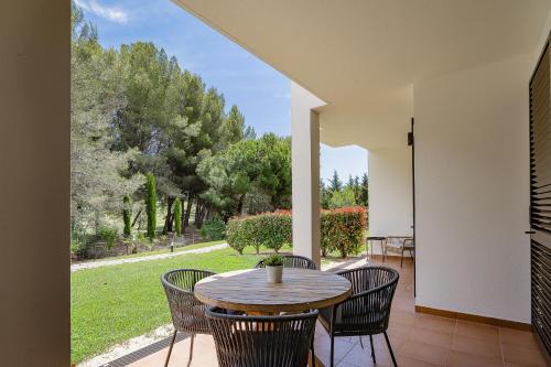 a table and chairs on a patio with a view at Dream 2BDR Apartment W/Pool by LovelyStay in Alvor