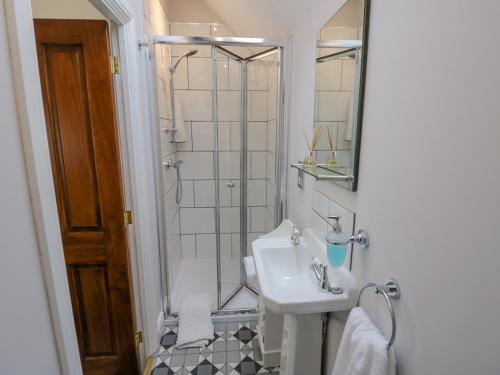 a bathroom with a sink and a shower at The Nest in Nuneaton