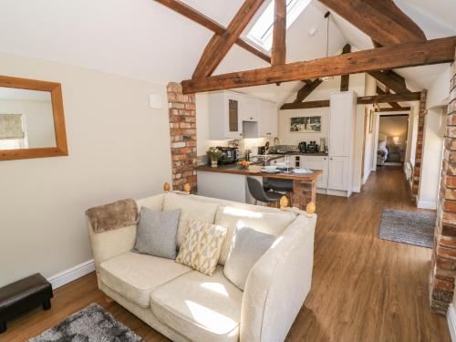 a living room with a couch and a kitchen at The Dairy in Nuneaton
