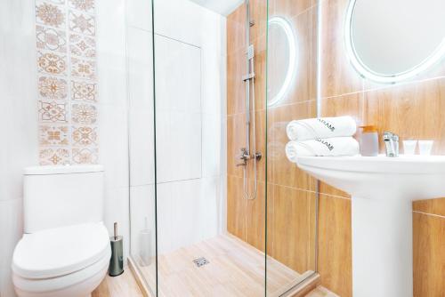 a bathroom with a toilet and a sink at Hotel Arami by Downtown in Yerevan