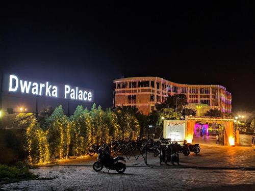 a group of motorcycles parked in a parking lot at night at Dwarka Palace Luxury Rooms, Madurai - Trichy Bye Pass, Madurai in Madurai
