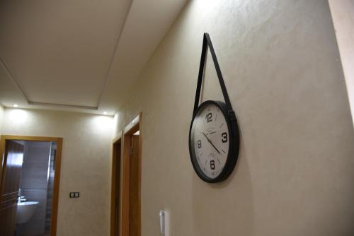 a clock hanging on a wall in a hallway at RAWAN RESIDENCY in Oujda