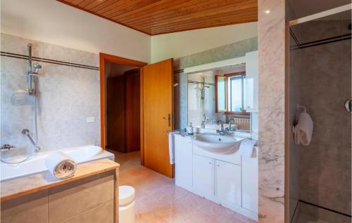 y baño con bañera, lavamanos y ducha. en Awesome Home In Saludecio With Wifi, en Saludecio