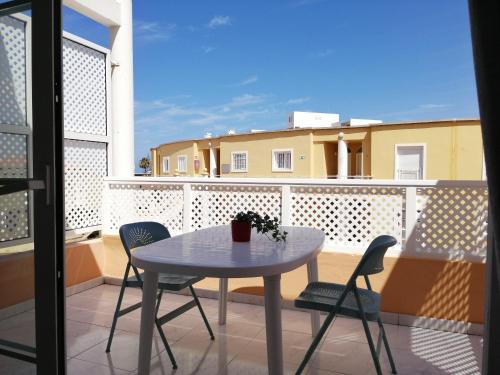 a small table and chairs on a balcony at Apartamento Costa Adeje - Orlando Complex in Adeje