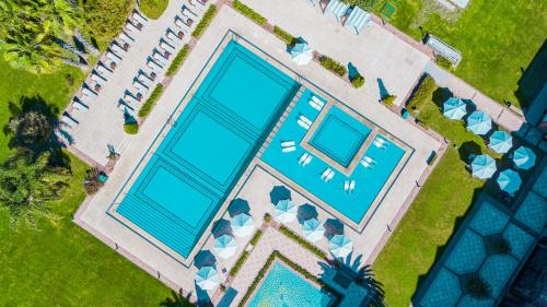 an overhead view of a swimming pool with blue water at Sheraton Pilar Hotel & Convention Center in Pilar