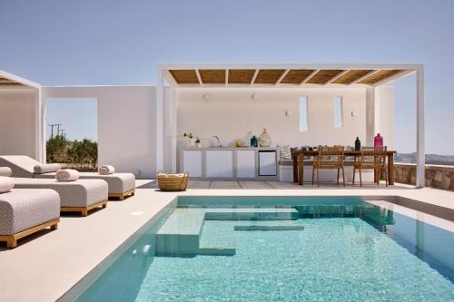 a villa with a swimming pool and a kitchen at Dot Milos in Adamantas