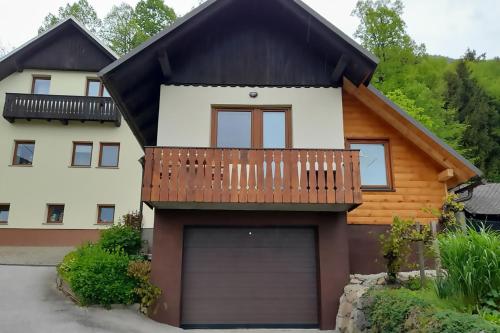 a house with a garage in front of it at Apartment Pr Dev in Begunje na Gorenjskem
