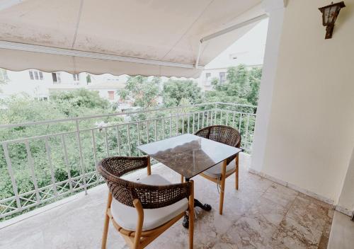 a table and chairs on a balcony with a view at ROH Suites in Athens