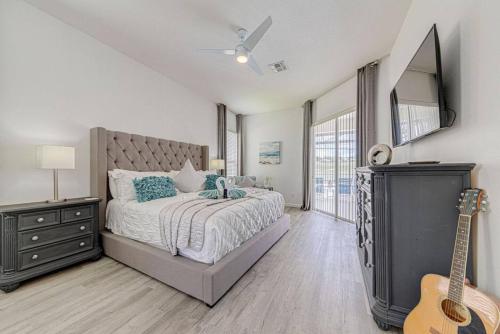 a bedroom with a bed and a guitar in it at 596 Modern 5 bed home overlooking beautiful golf course and conservation with Games room in Davenport