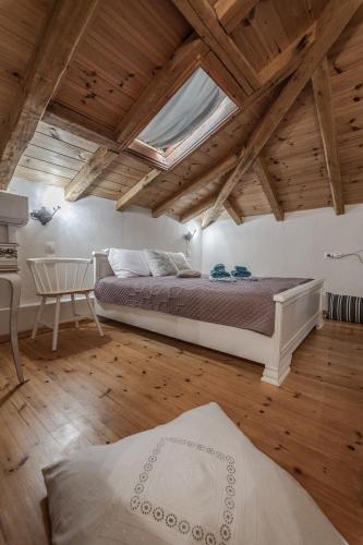 a bedroom with a bed and a skylight at Cicones Boutique Apartments in Skiathos