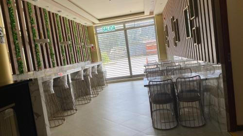a row of tables and chairs in a room at R&N SHULLKAS SUITES in Huancayo