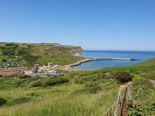 a view of the ocean from a hill at Saltburn Holidays 1 Park View Loftus in Loftus