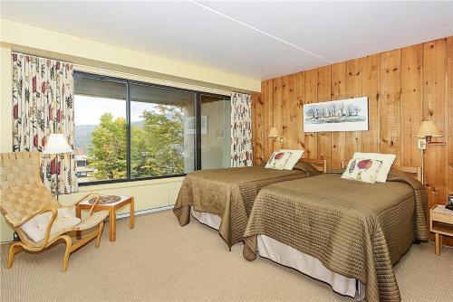 a hotel room with two beds and a window at Notchbrook 20AB in Stowe